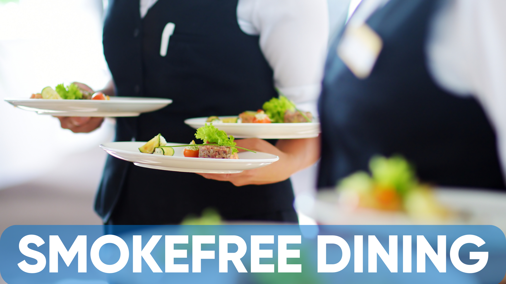 The words, 'Smokefree Dining,' over an image of some fancy meals being carried by waitstaff.