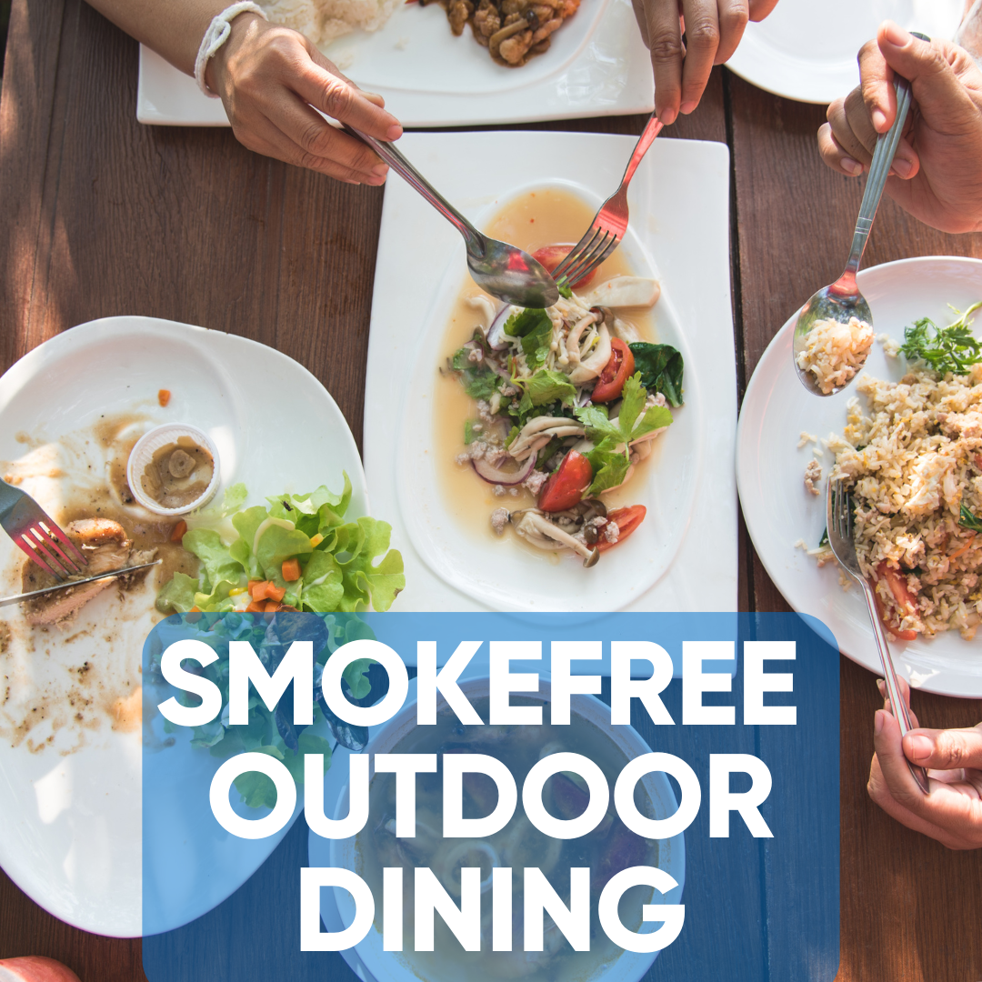 The words, 'Smokefree Outdoor Dining,' over a top-down view of several dishes being eaten.