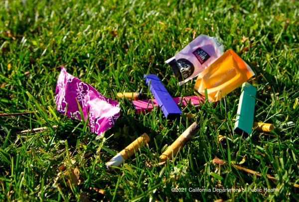 lawn with vape pens and cigarette butts